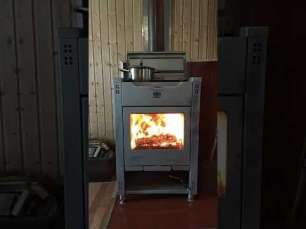 Стальной камин со стеклом Теплодар Кадриль фото в интерьере в Минске